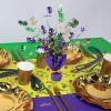 Beistle Mardi Gras Centerpiece & Confetti Set – 15″ Gleam ‘N Burst Table Decoration with Purple Base & Gold Ribbon and ½ Ounce Metallic Mardi Gras Scatter, Party Décor for Celebrations and Events